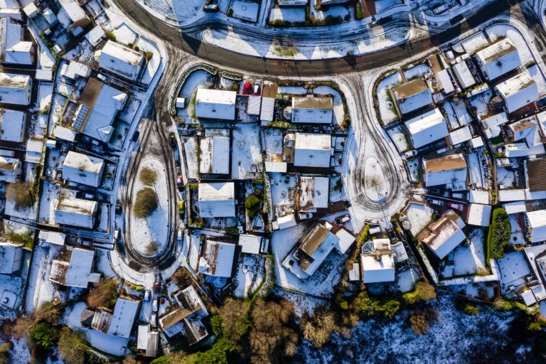 Winter scene overhead aerial view of suburban cul de sacs with light cover of snow